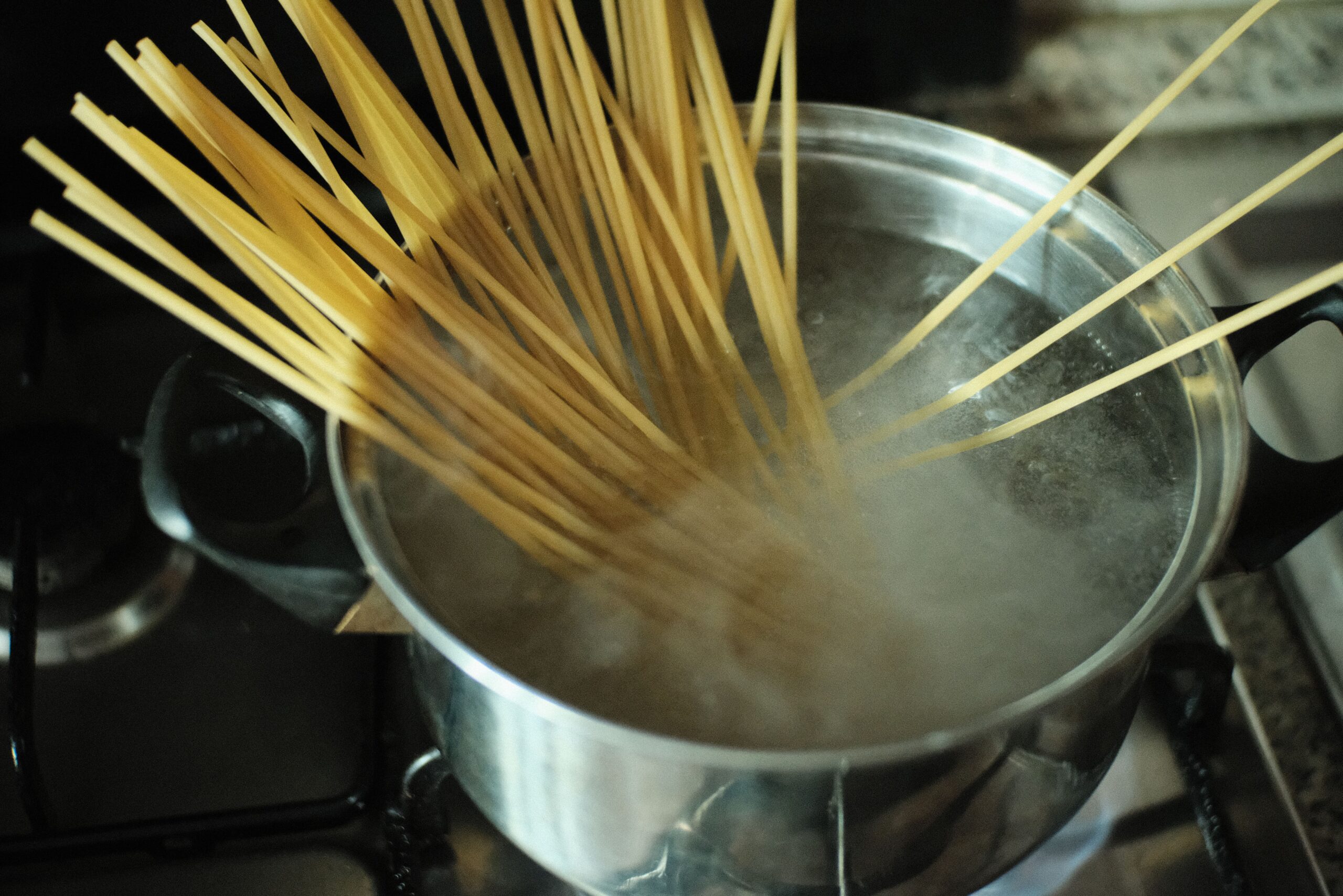 Elbow pasta boiling in a pot of water for homemade mac and cheese