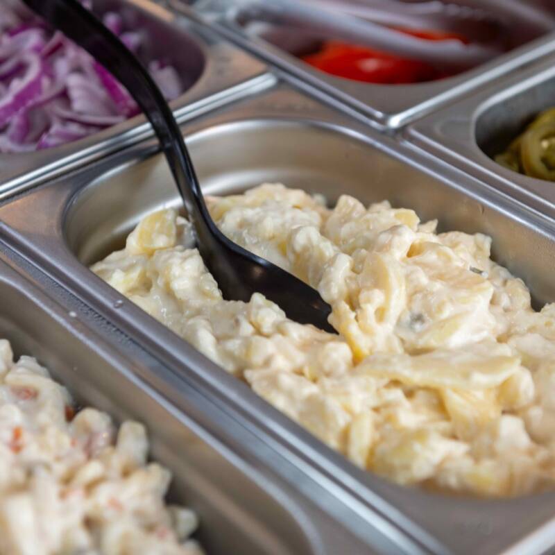 Creamy potato salad served in a bowl at a buffet-style gathering