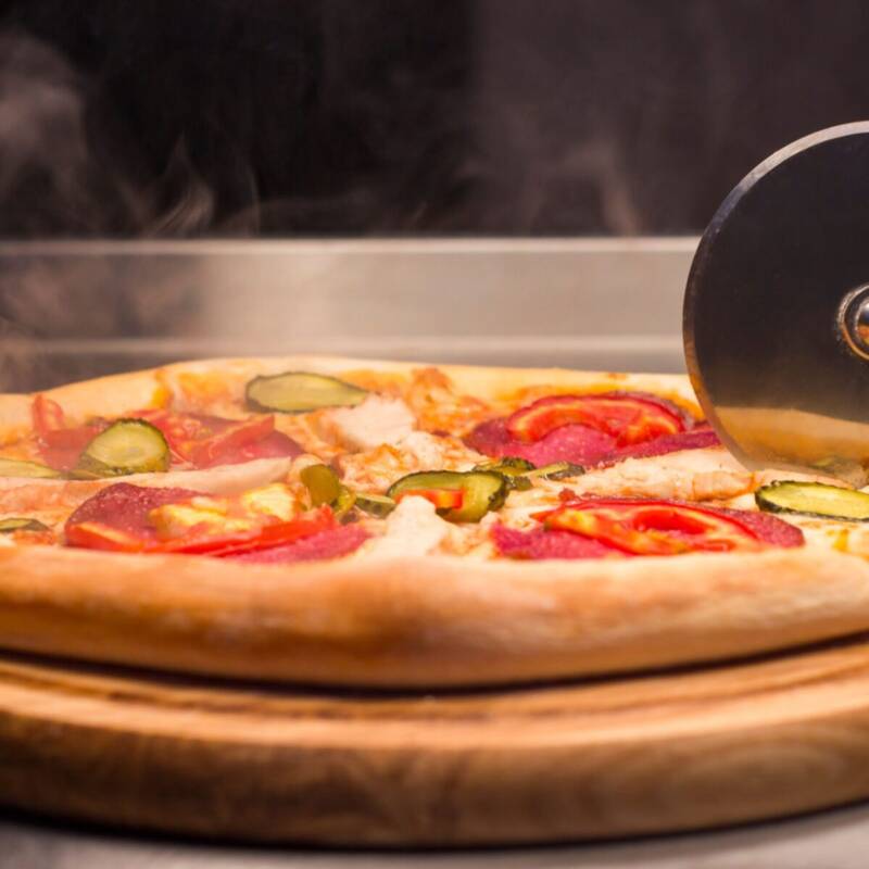 Golden baked pizza made from homemade pizza dough sliced and ready to serve