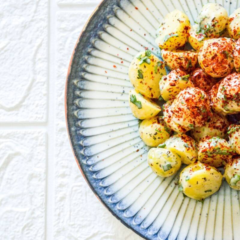 Bowl of classic potato salad with chopped eggs, celery, and a creamy mayo dressing