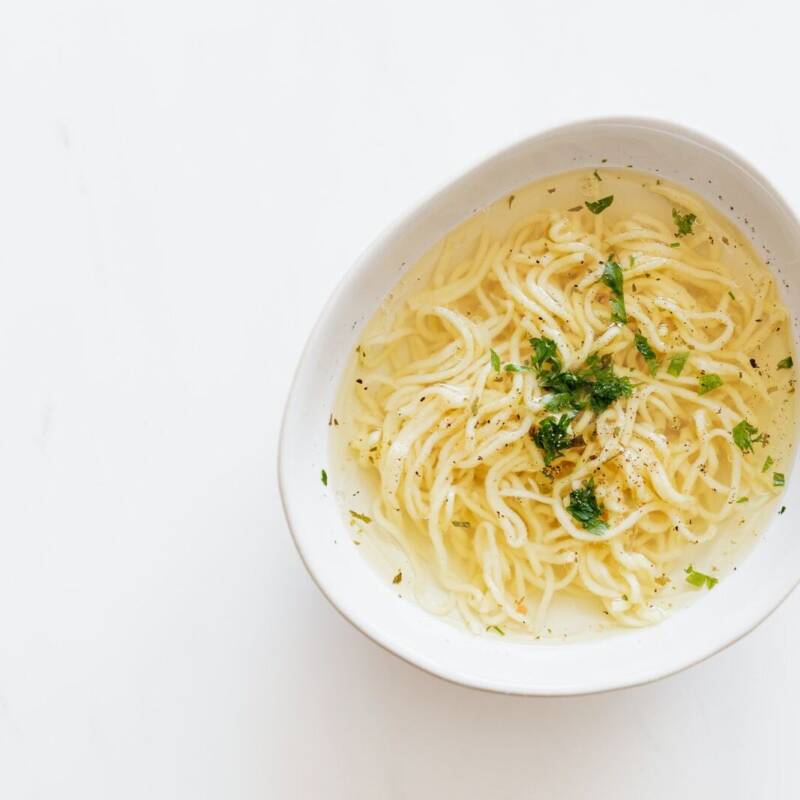 Bowl of homemade chicken noodle soup with parsley