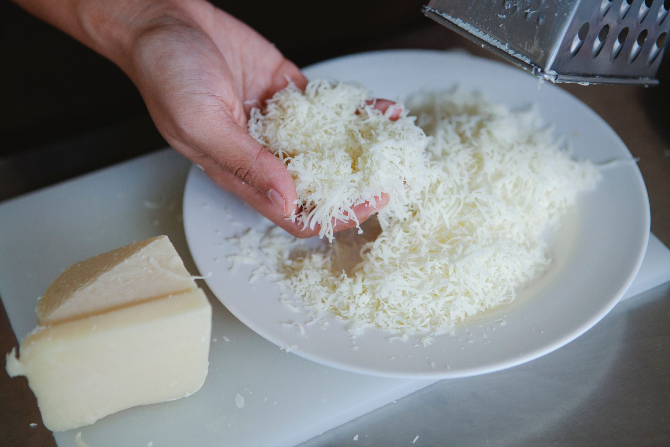 Freshly grated cheese for a smooth homemade mac and cheese sauce