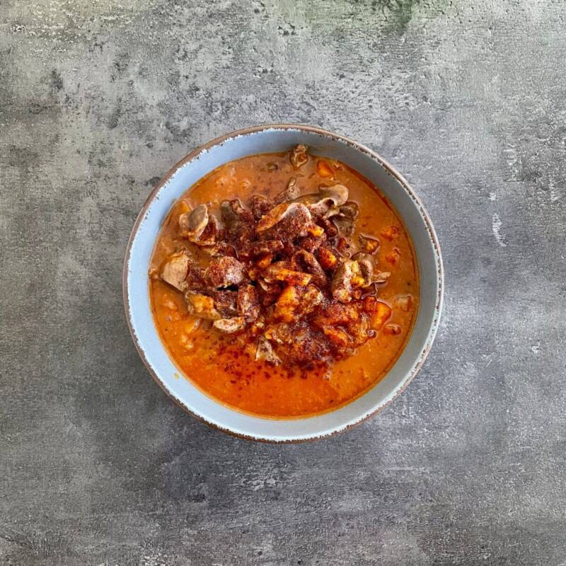 Hearty beef chili stew in a pot with spices